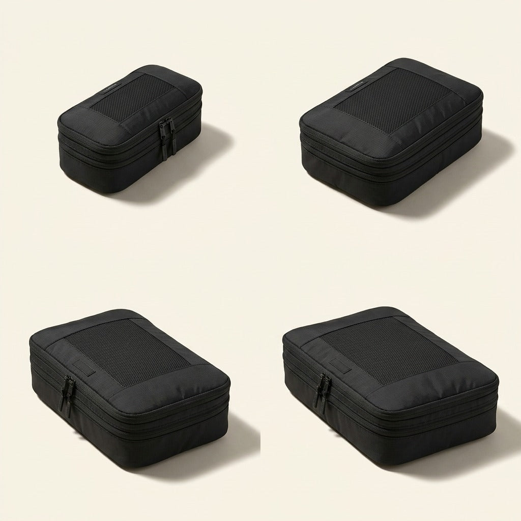 Set of four black Bugatti compression packing cubes in varied sizes with mesh panels on cream background.