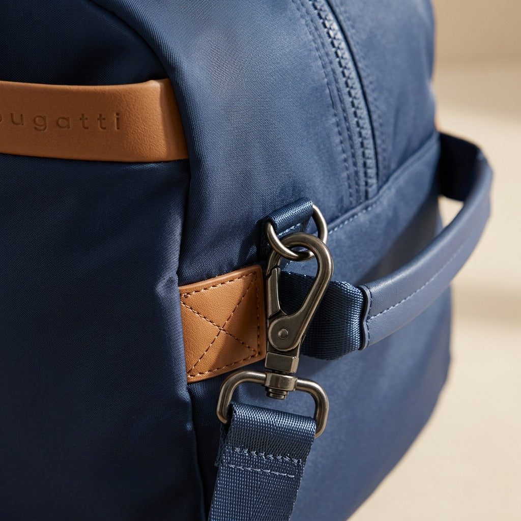 Close-up of the Bugatti Convertible Weekender in navy showing gunmetal hardware and tan trim.