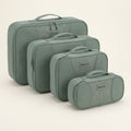 A four-piece set of Bugatti compression packing cubes in sage green, neatly tiered by size.